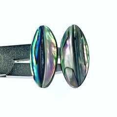 A pair of oval-shaped, hand-made natural abalone shell beads with a faceted surface.