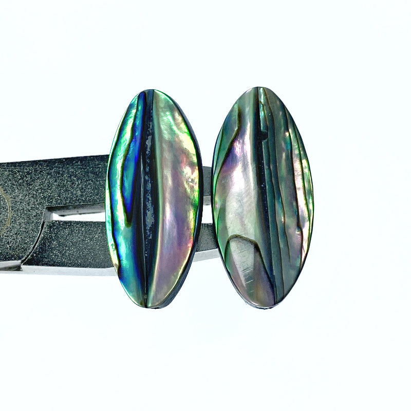 A pair of oval-shaped, hand-made natural abalone shell beads with a faceted surface.