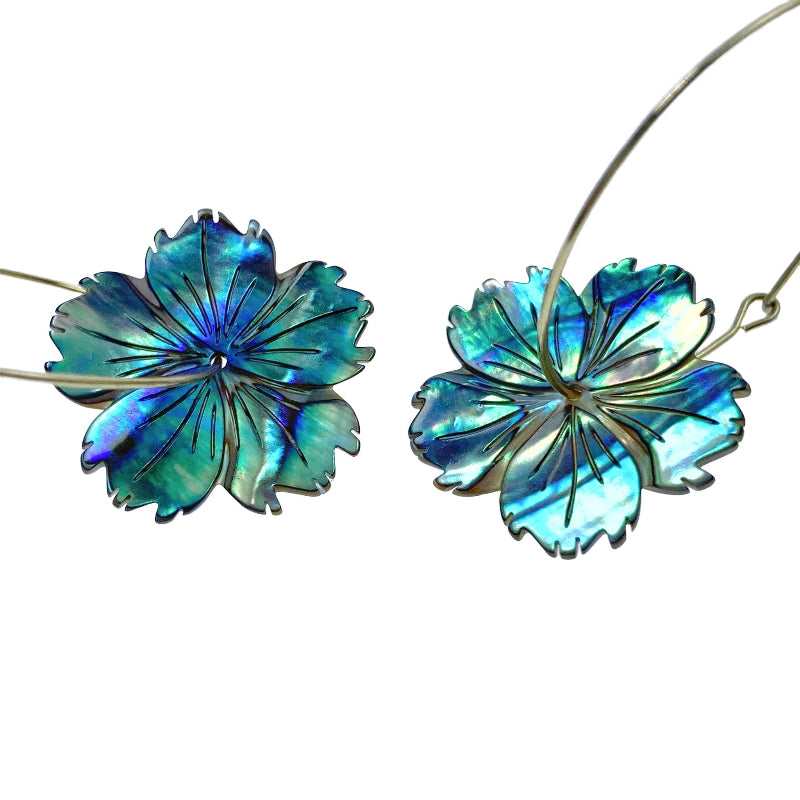 A hand-carved abalone shell flower bead with a natural color pattern resembling a hibiscus flower.